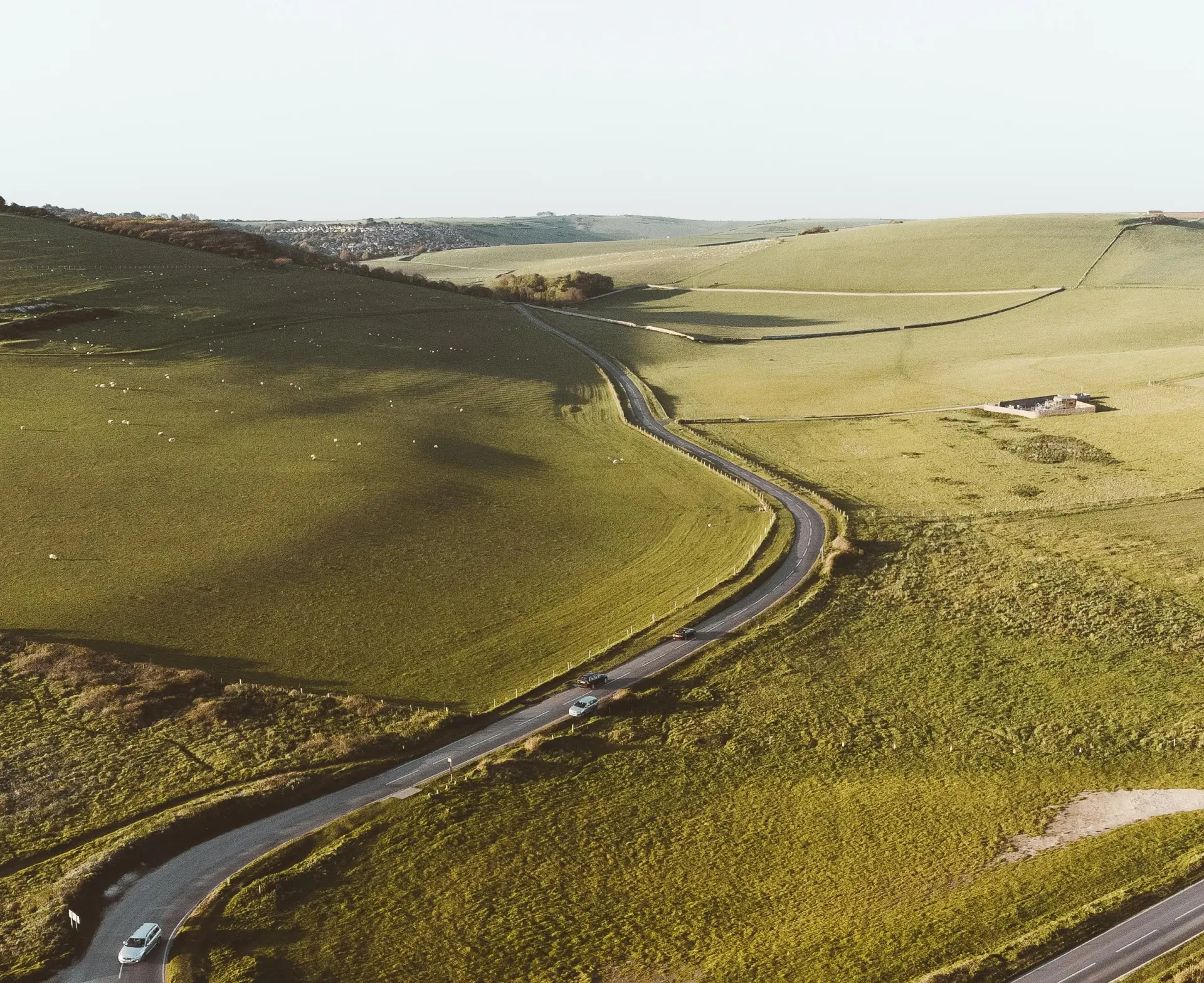 a road through a green field