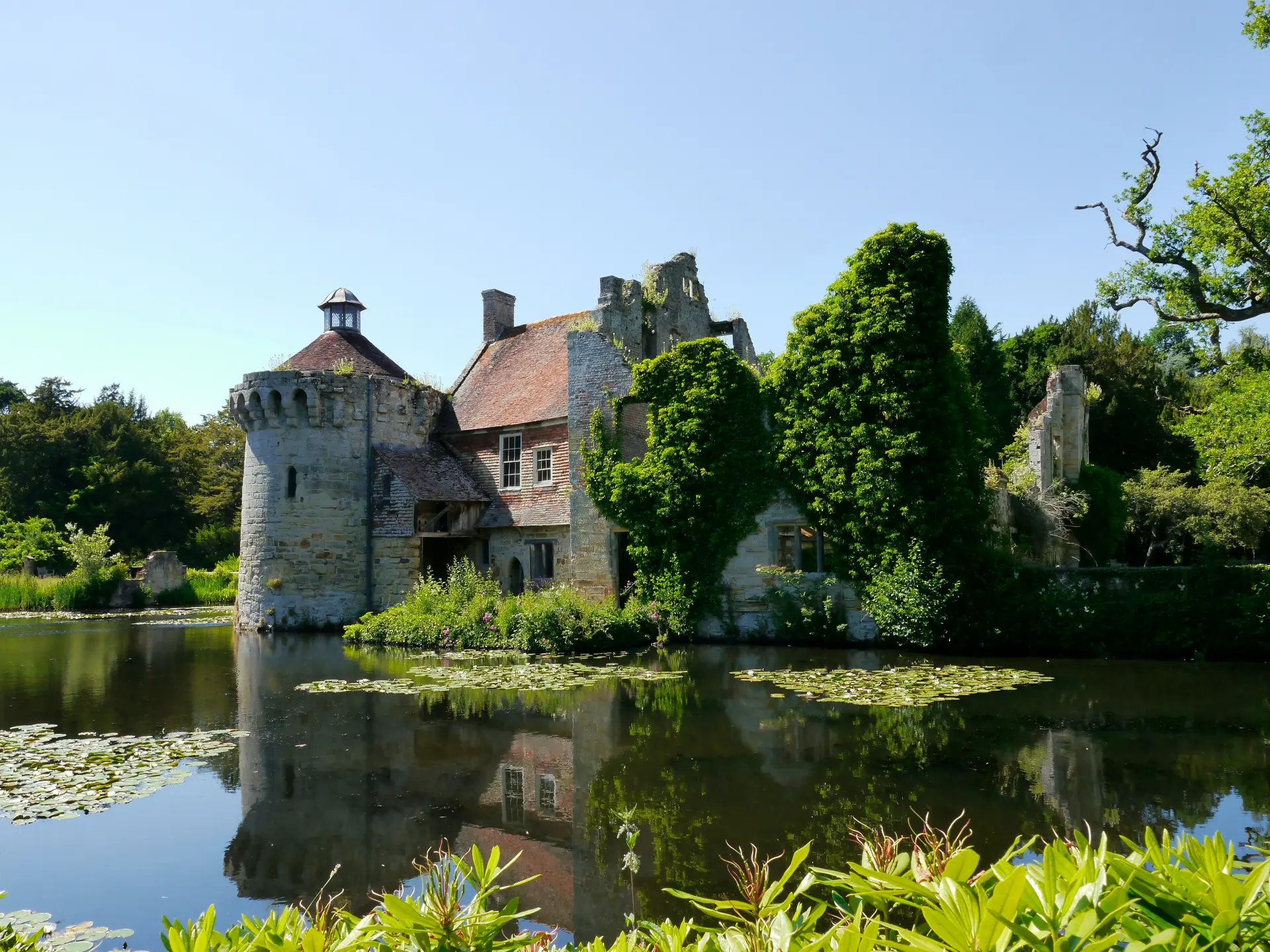 a building with a tower and a pond with water