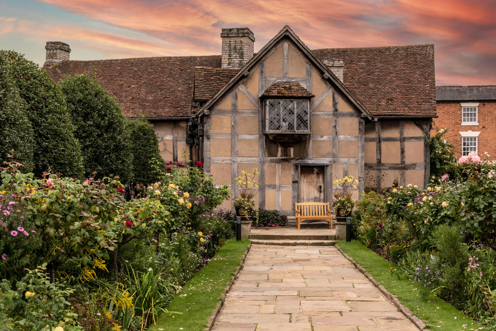 a house with a garden and a bench