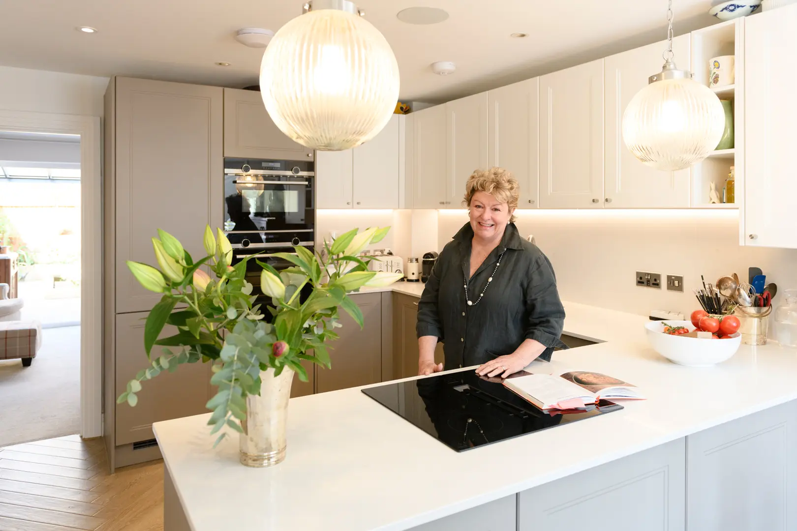 a woman standing in a kitchen