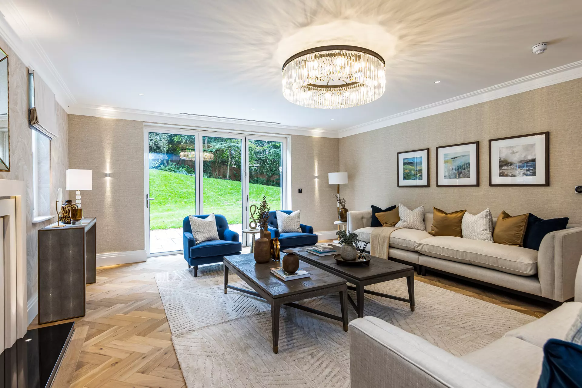 a living room with a chandelier and couches