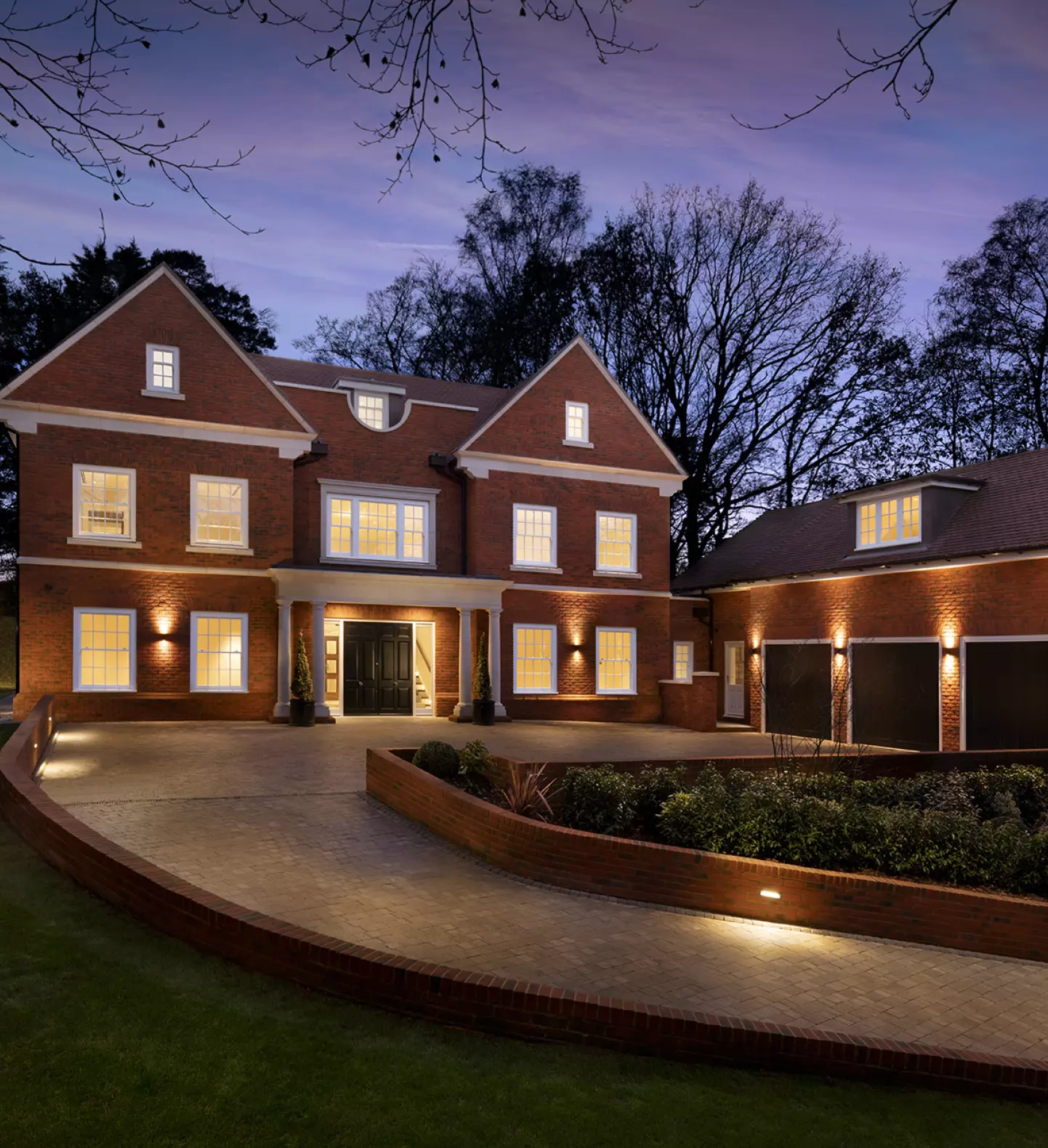 a large brick house with a driveway and a driveway