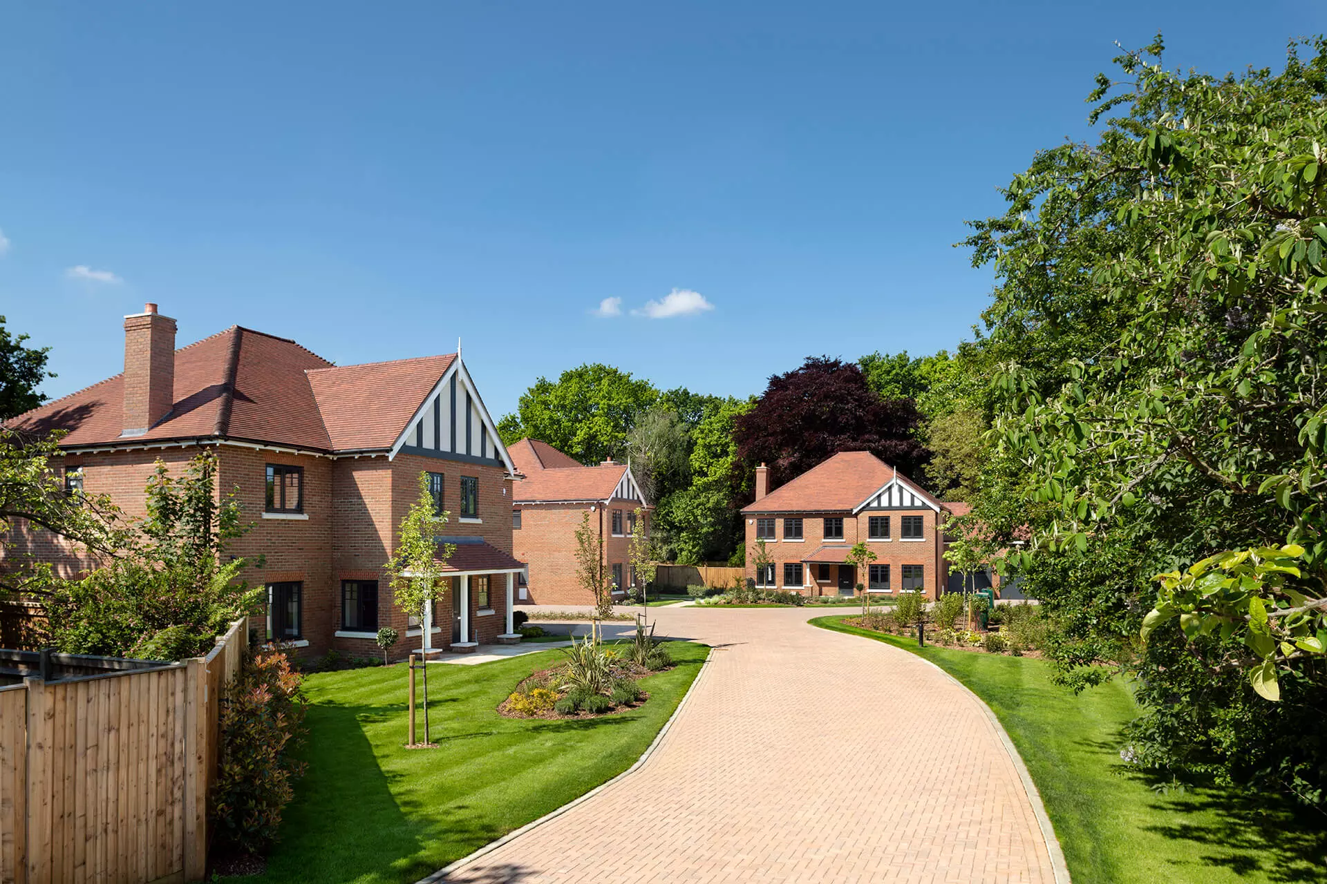 a brick road leading to a row of houses