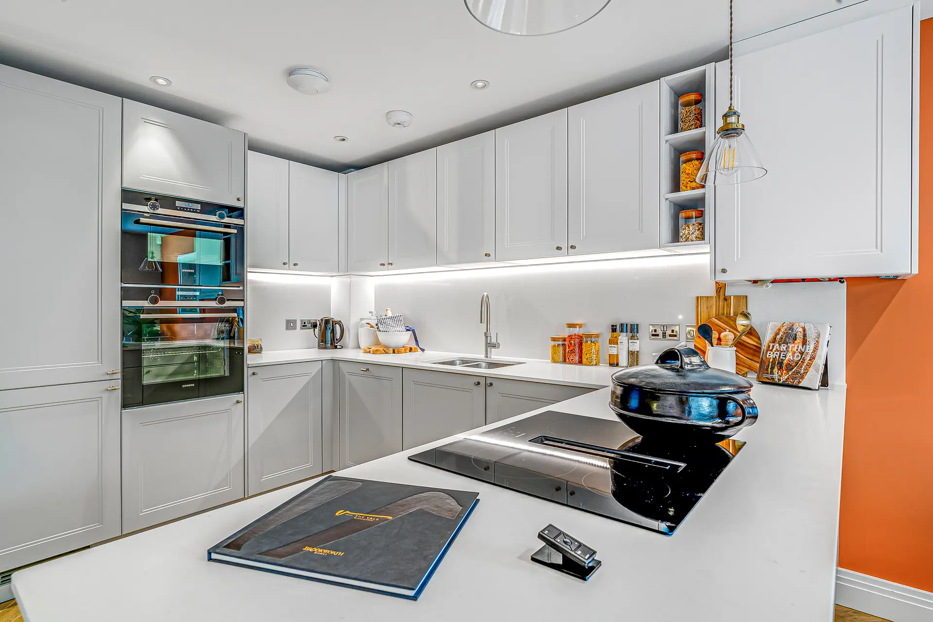 a kitchen with white cabinets and a black stove
