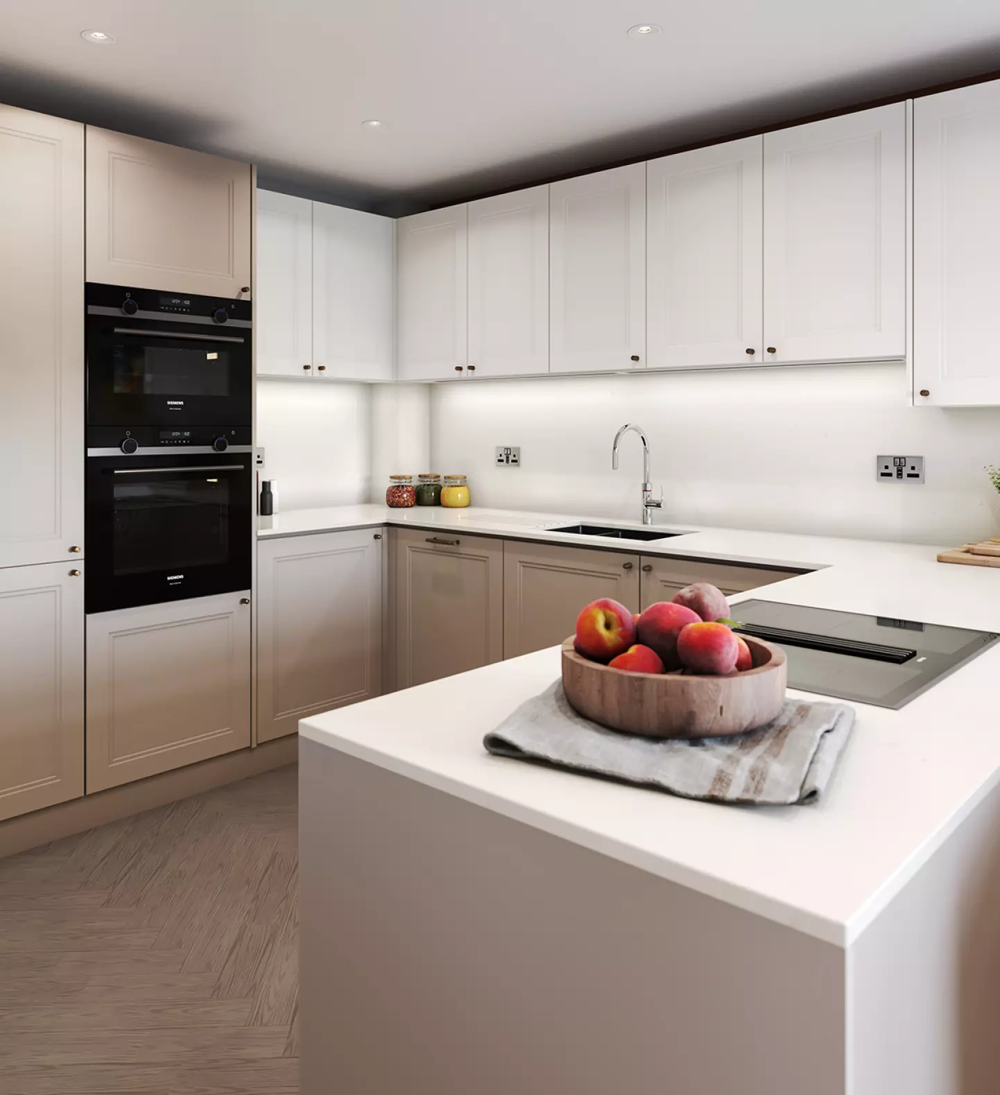 a kitchen with white cabinets and a bowl of fruit