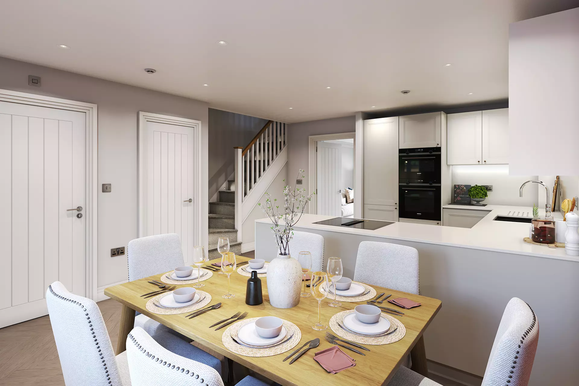 a dining table with white chairs and a white kitchen