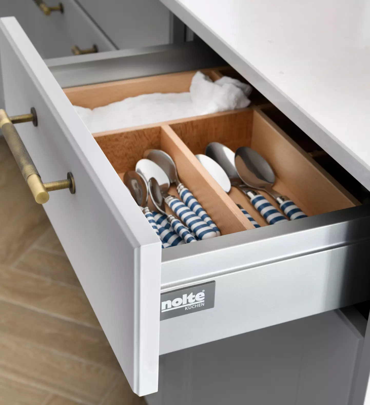 a drawer with spoons and forks in it