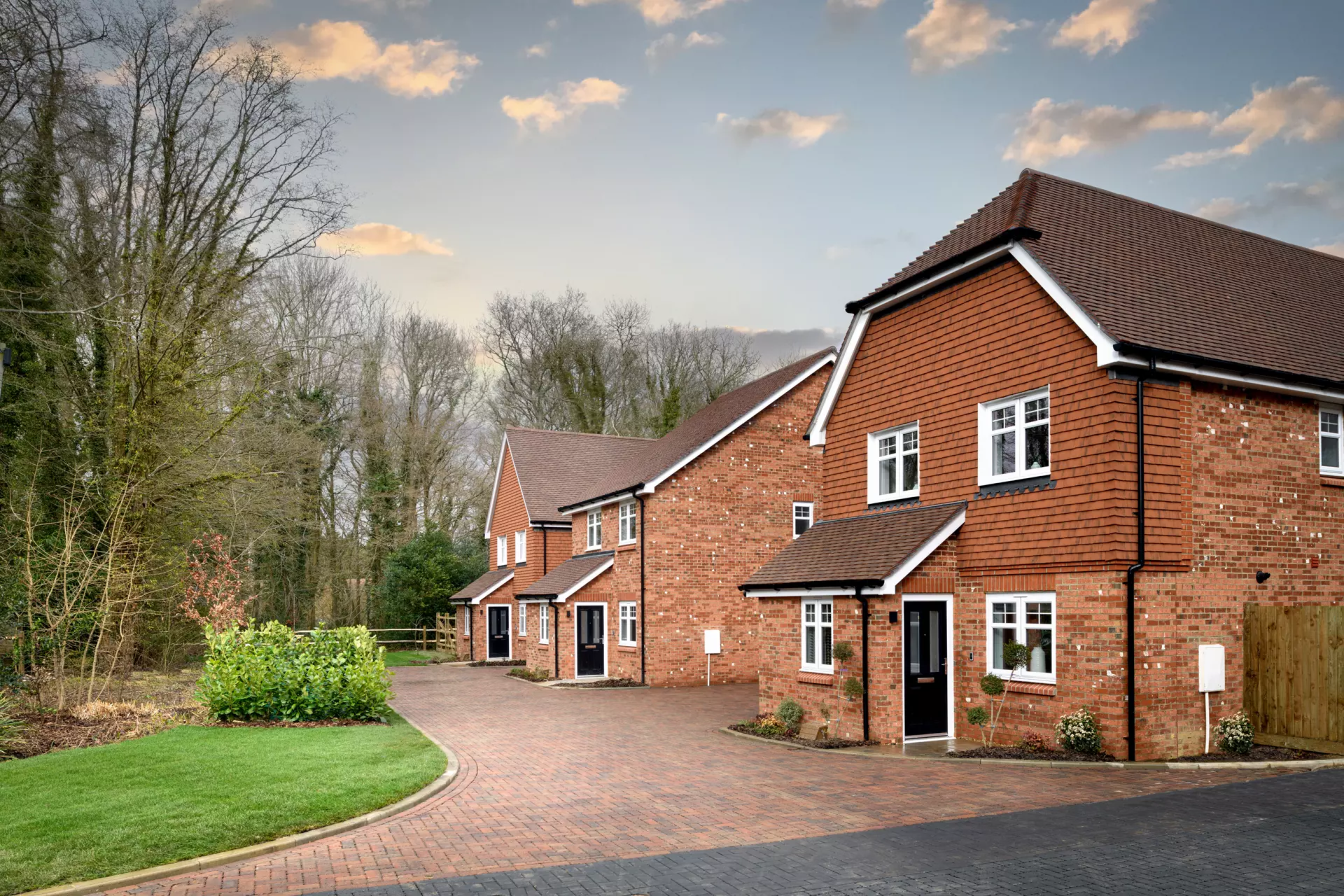 a brick houses with trees and grass