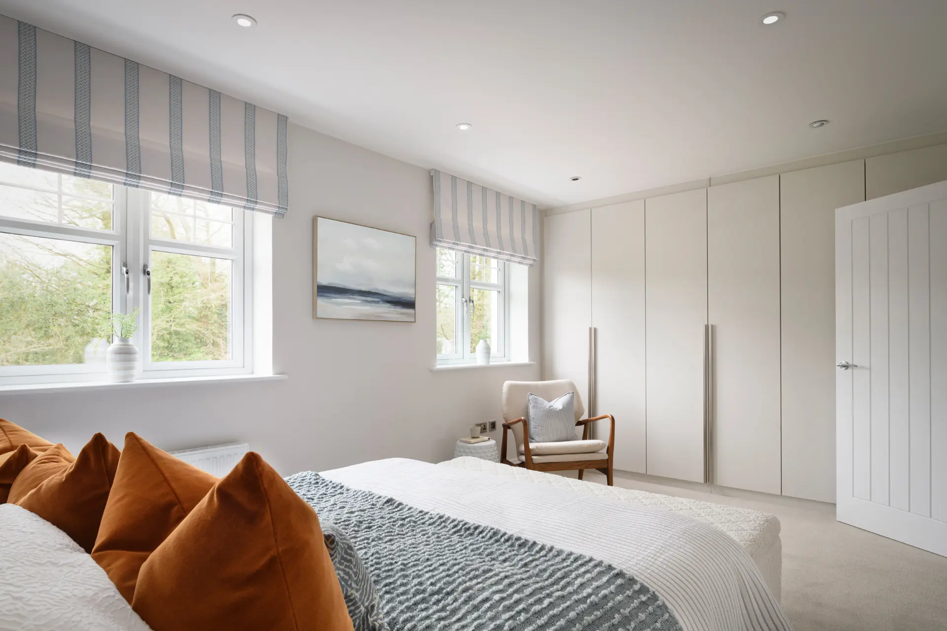 a bedroom with a bed and a chair