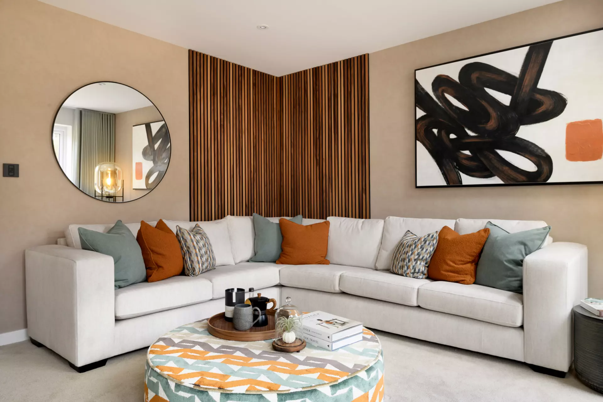 a living room with a round mirror and a white couch