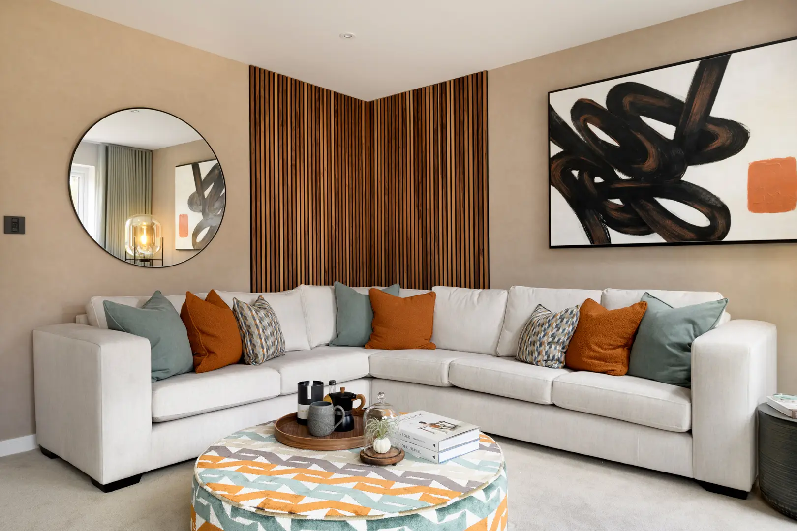 a living room with a round mirror and a white couch