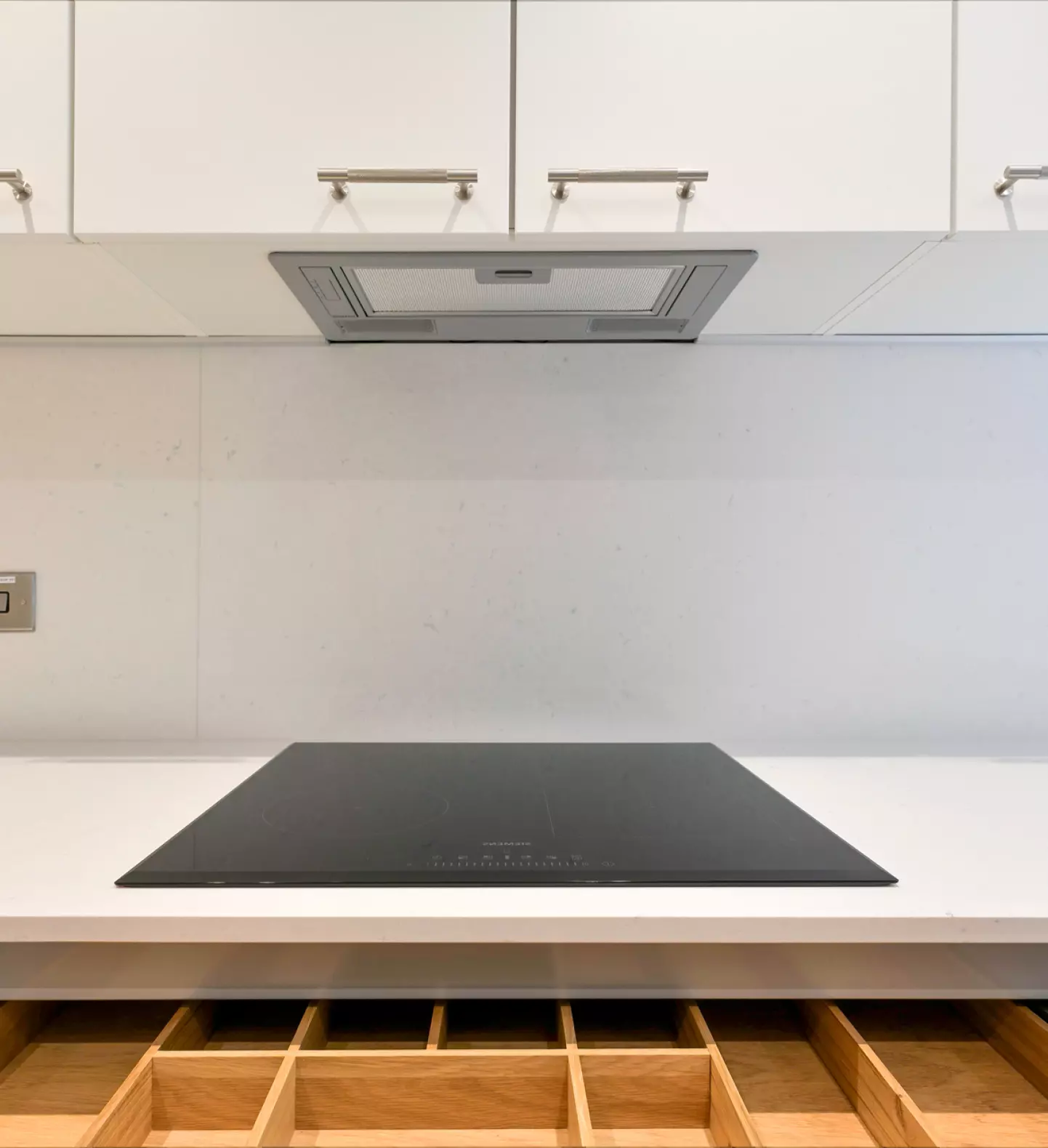 a white kitchen with a black stove