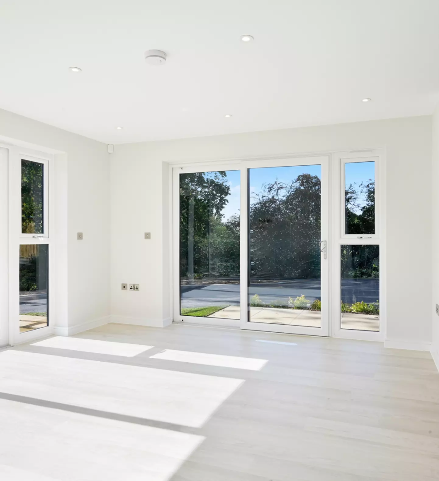 a room with white walls and glass doors