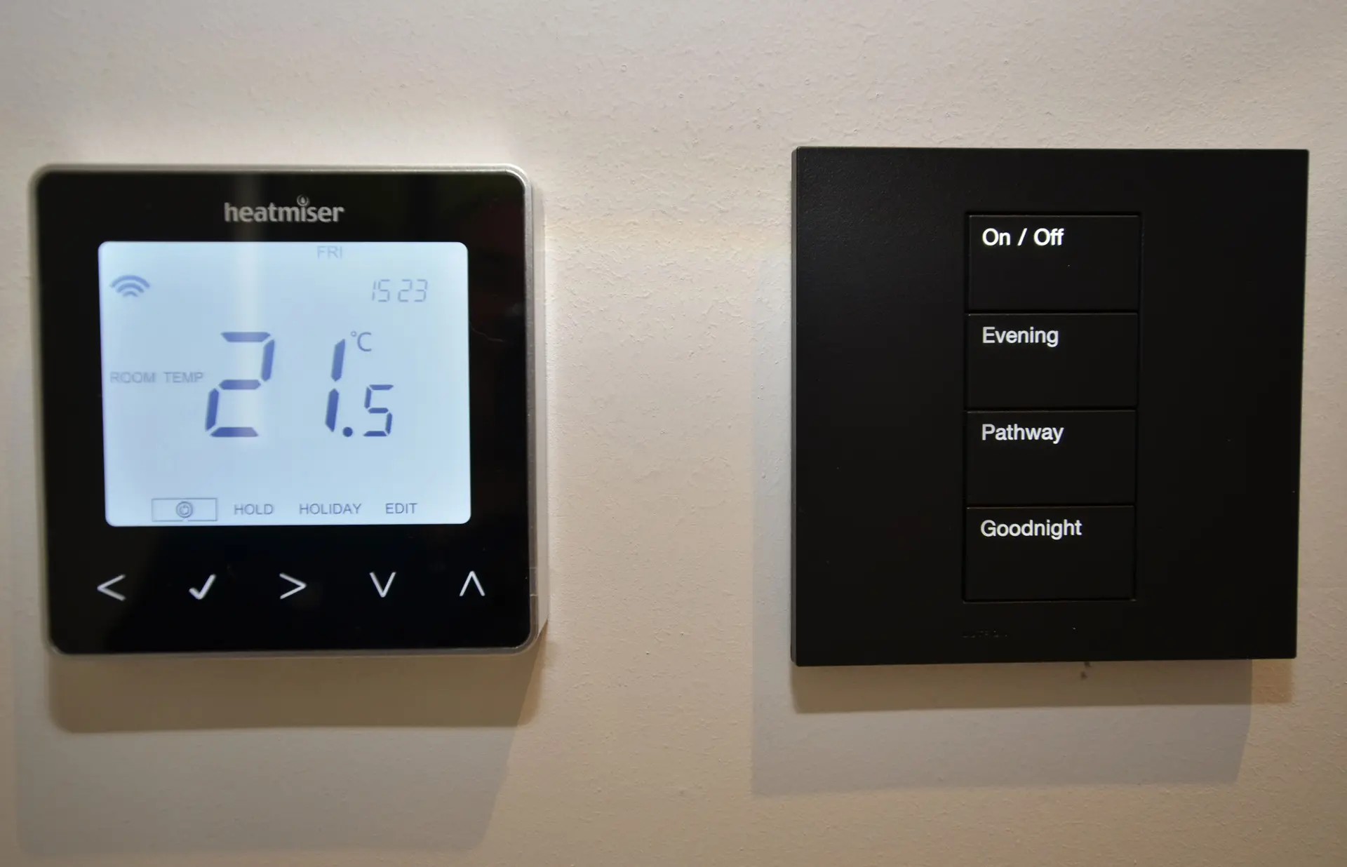 a digital thermostat and a black switch