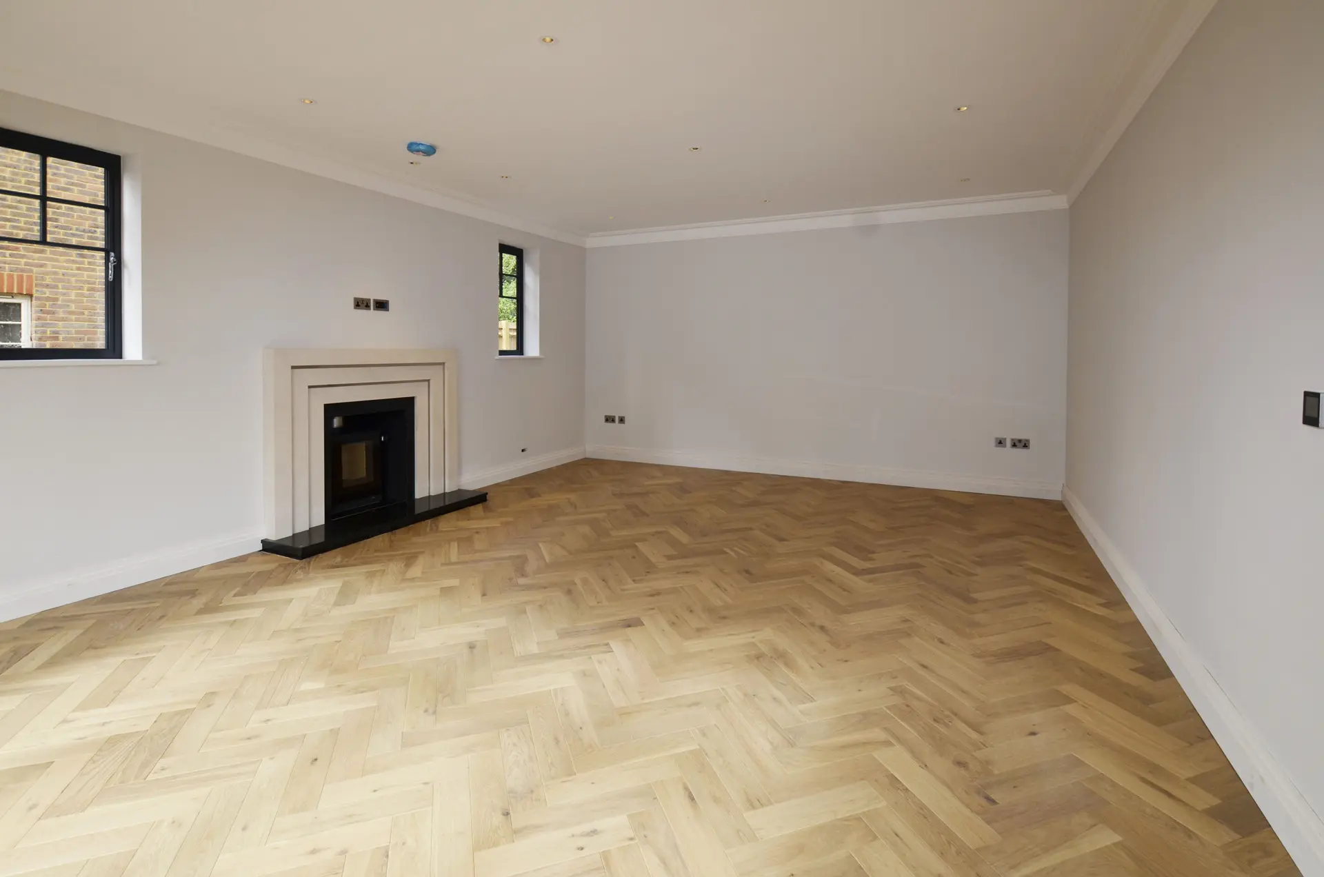 a room with a fireplace and a wood floor