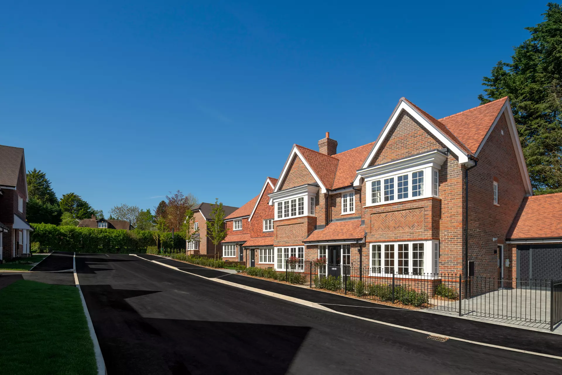 a brick house with a fenced driveway
