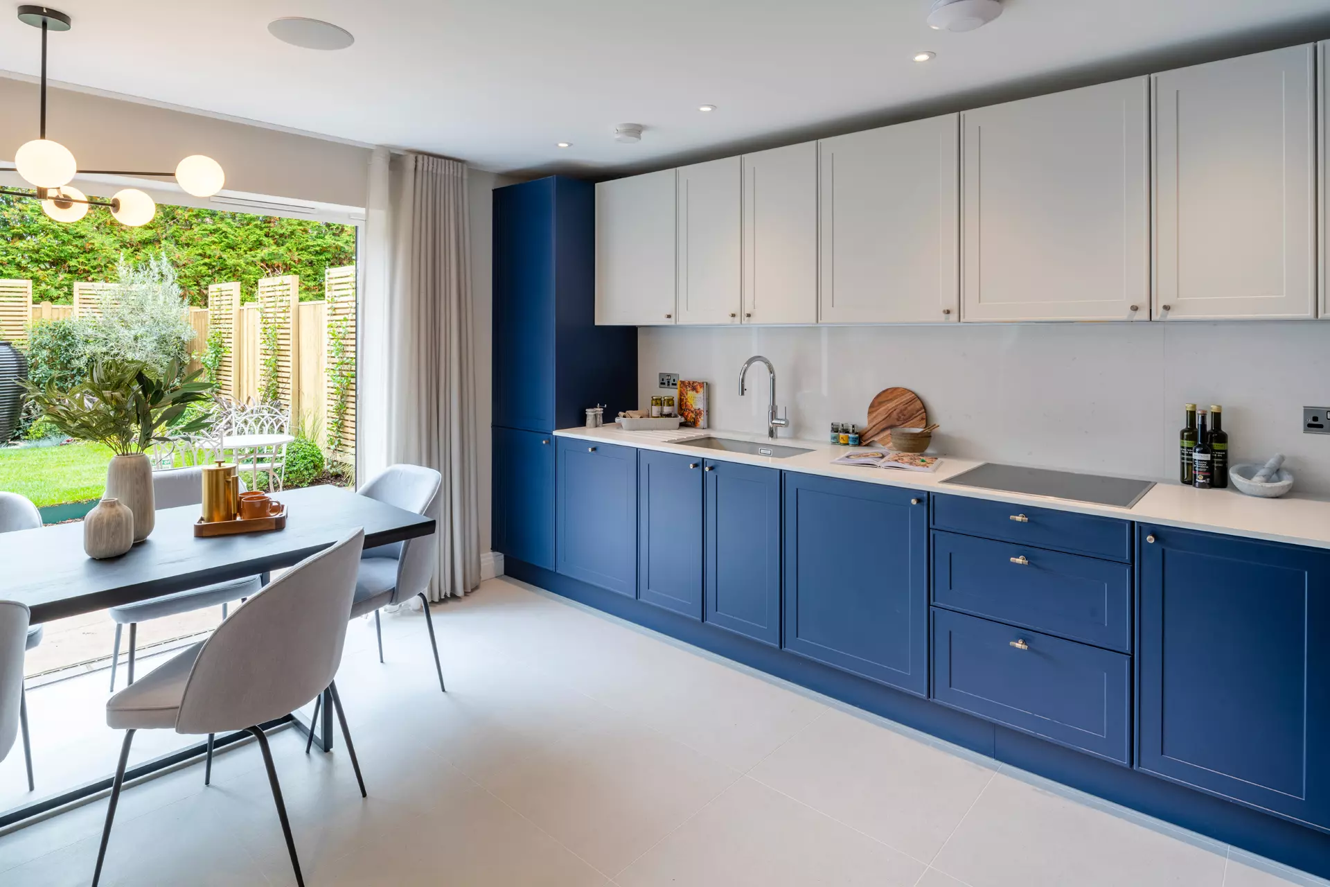 a kitchen with blue cabinets and white walls