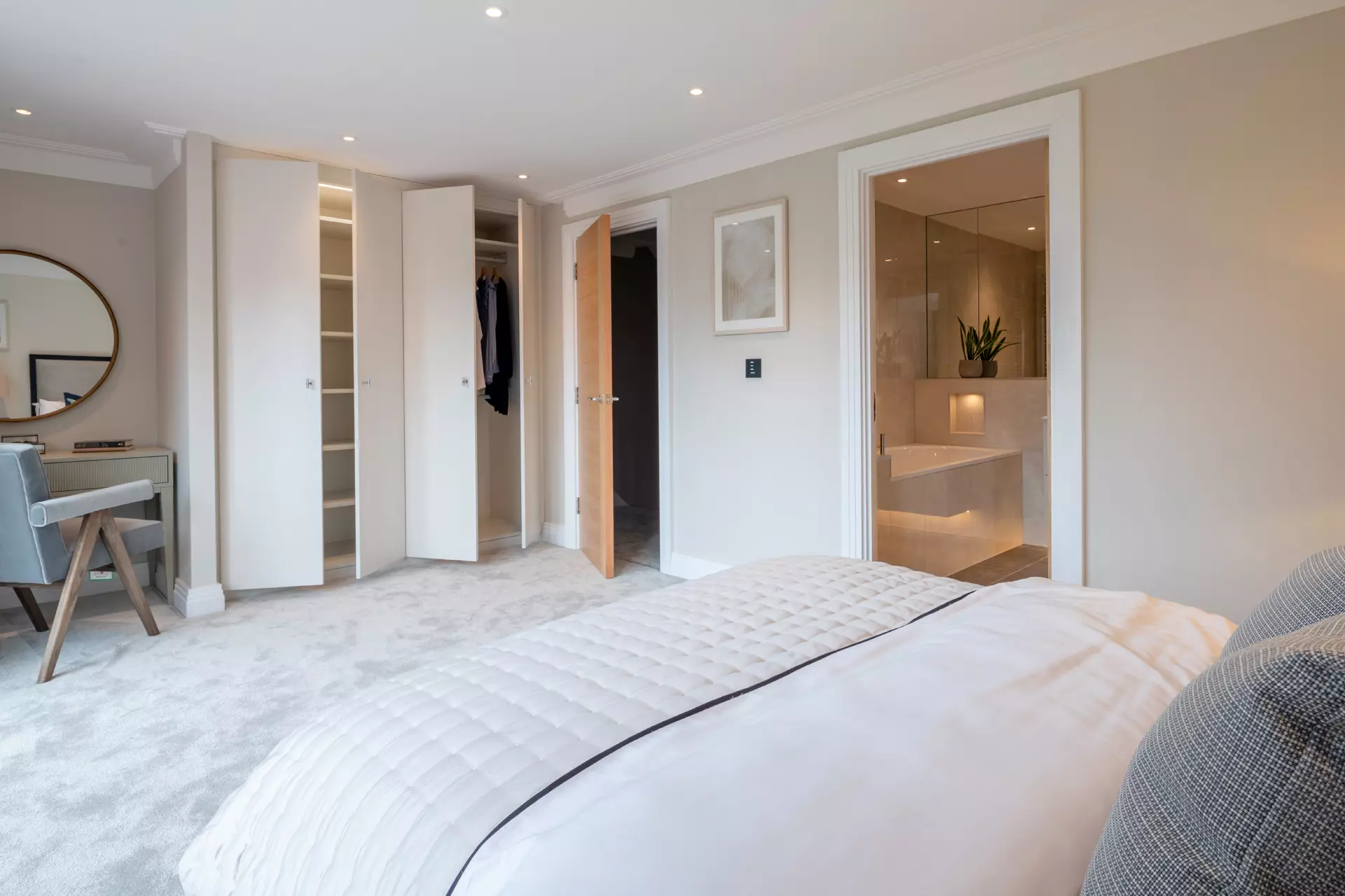 a bedroom with a white bed and closet doors