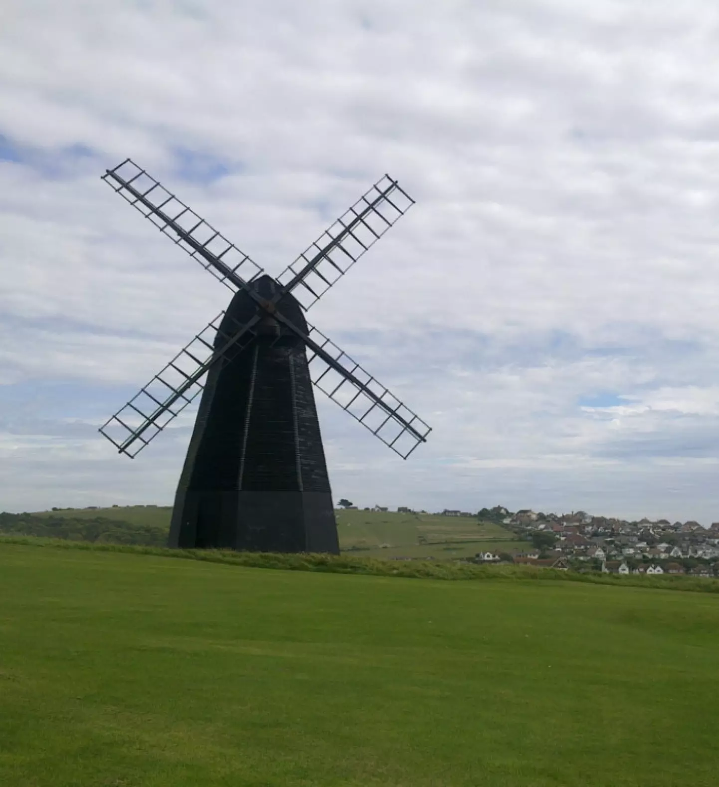 a windmill in a grassy field
