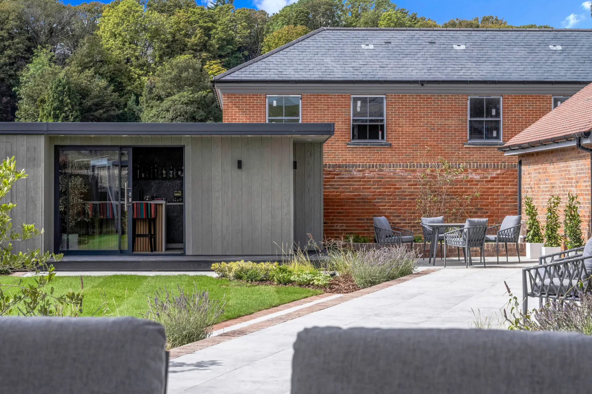 a patio with chairs and a brick building