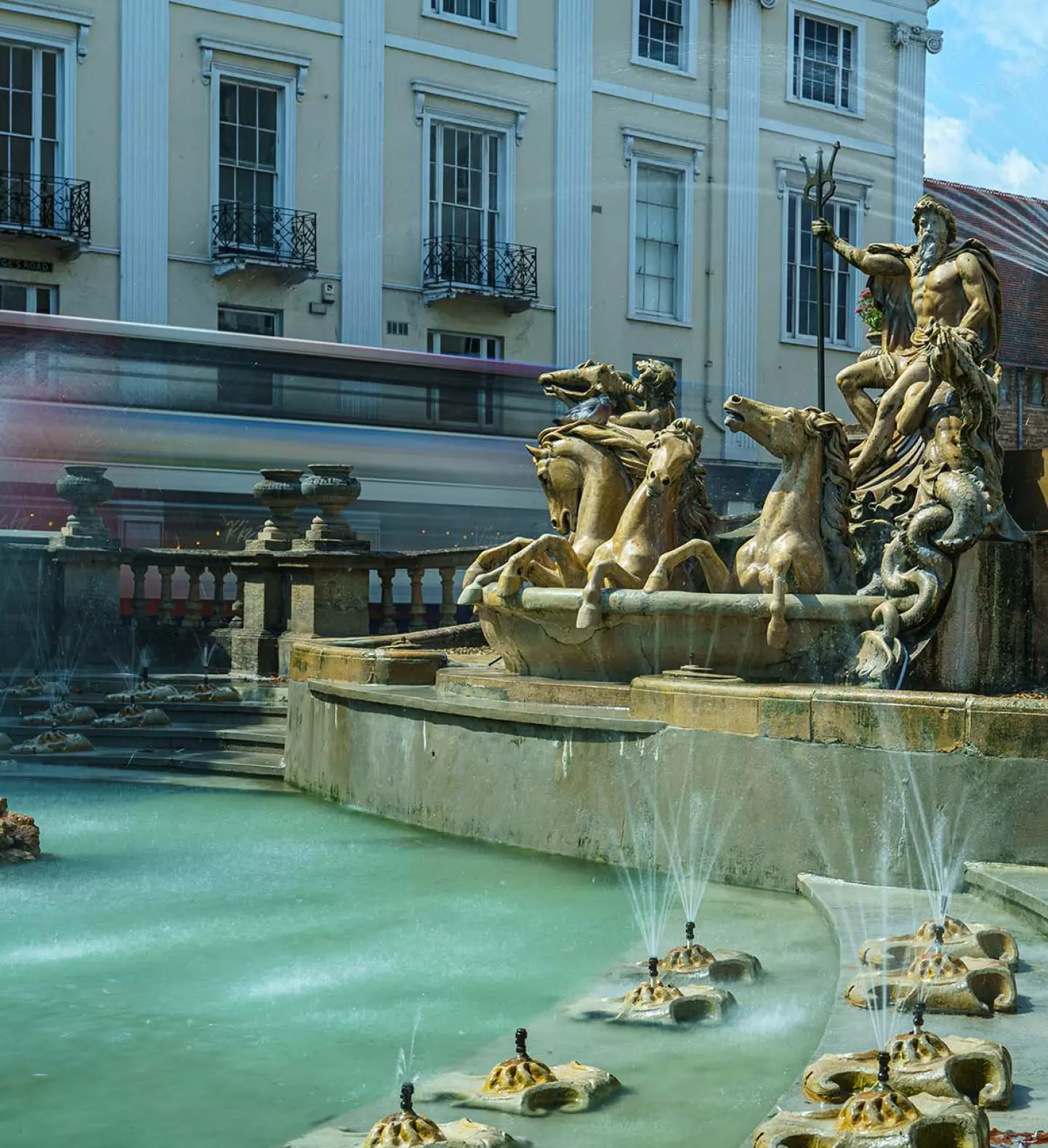 a fountain with statues and water spouting out of it