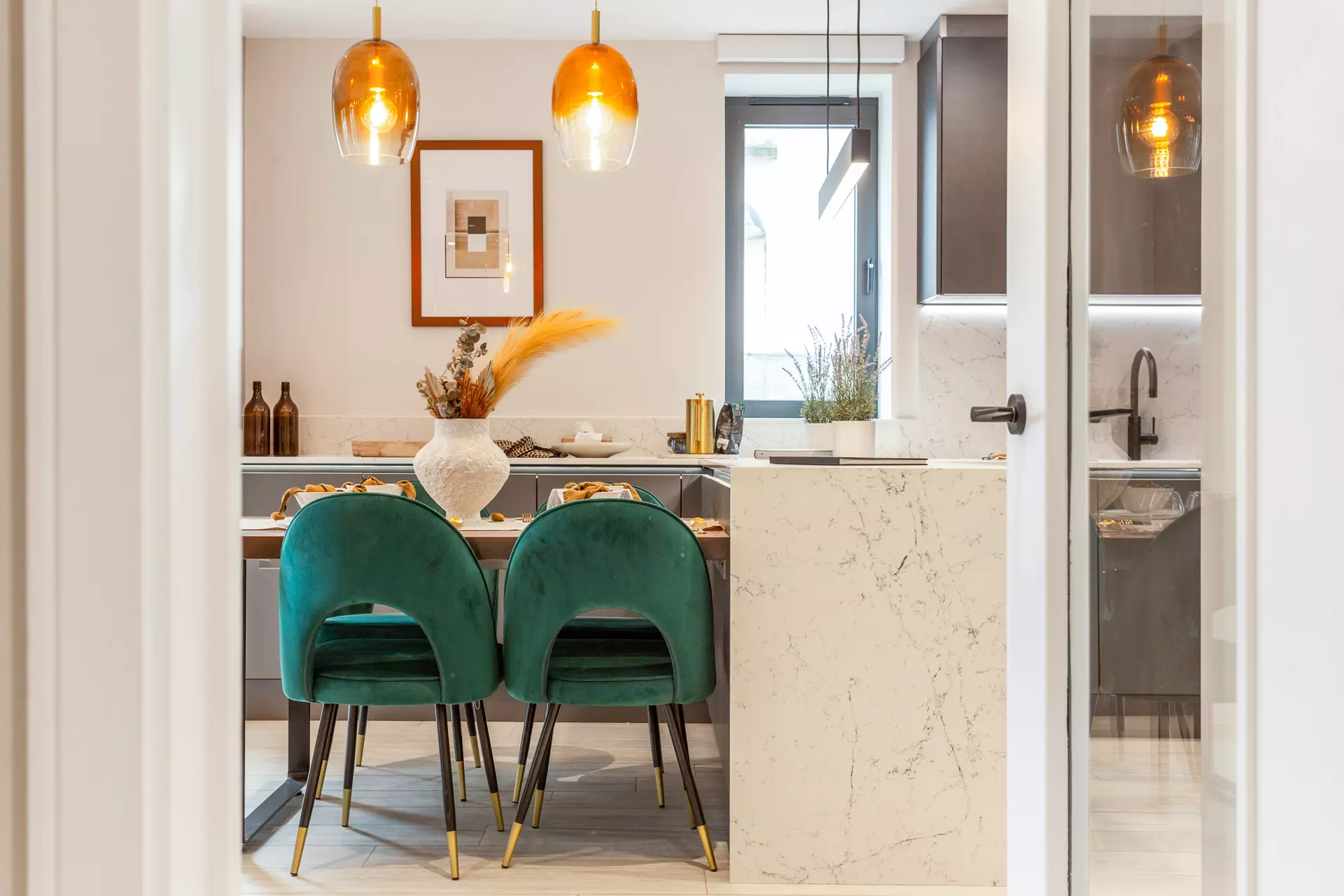 a dining table with chairs and a marble counter