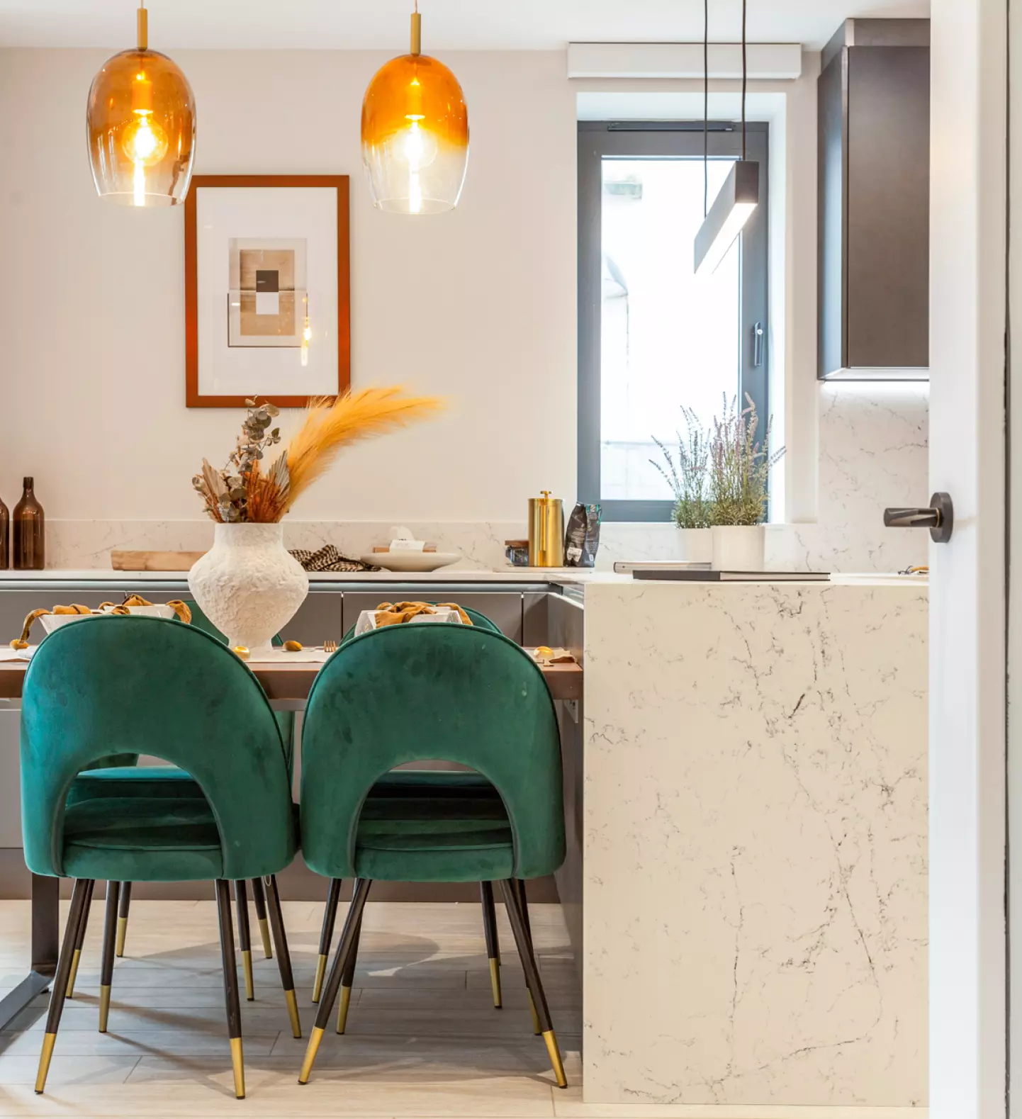 a dining table with chairs and a marble counter