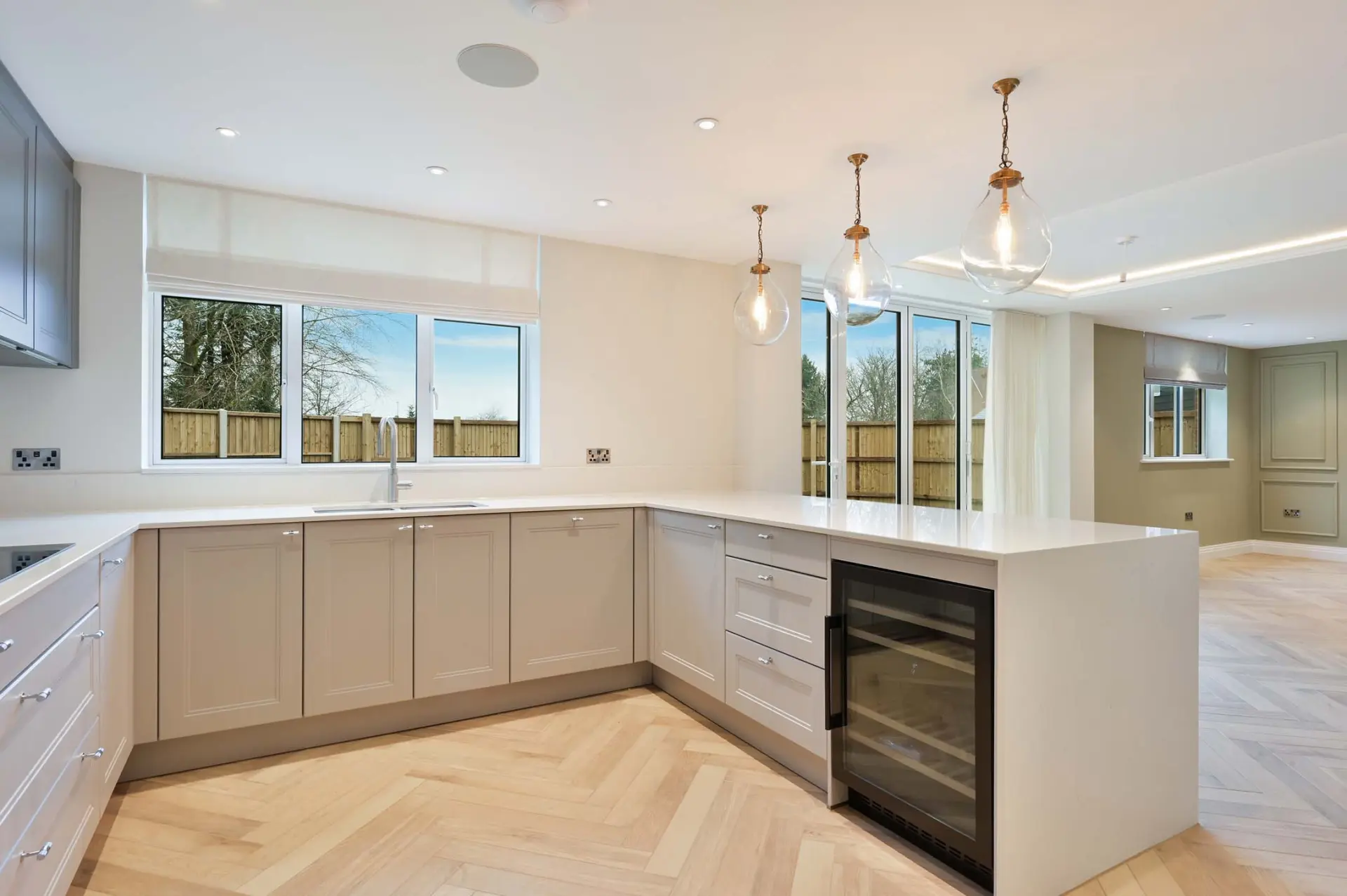a kitchen with white cabinets and a wood floor