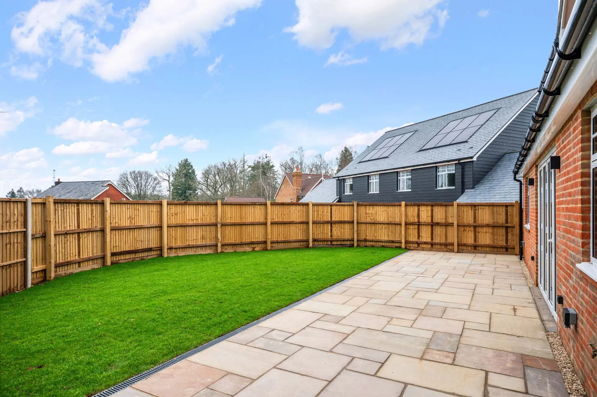 a backyard with a fence and a house