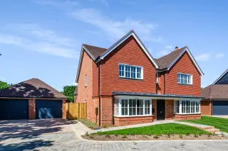 a brick house with a garage and a driveway
