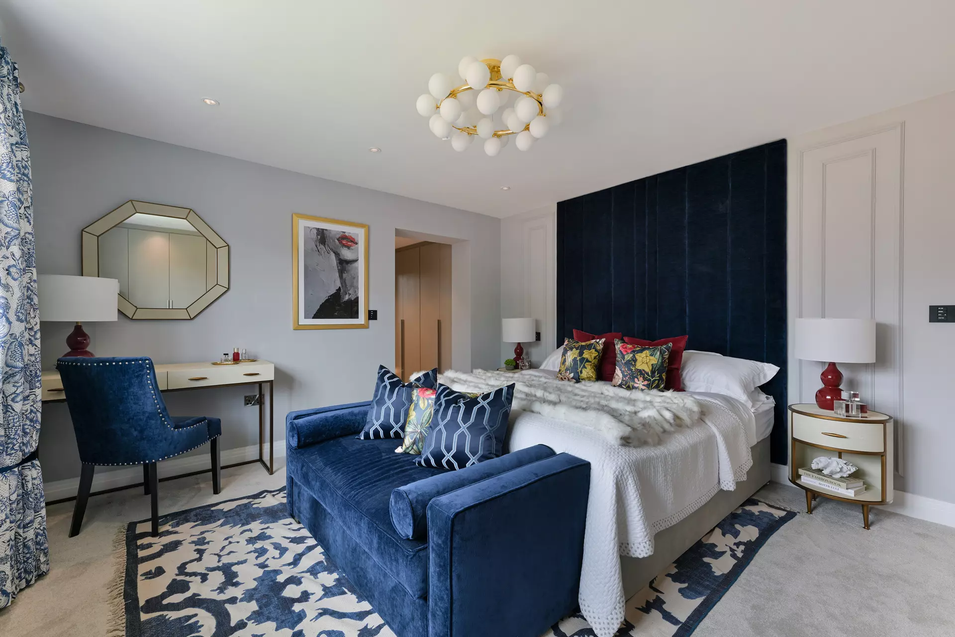 a bedroom with a blue couch and a blue chair