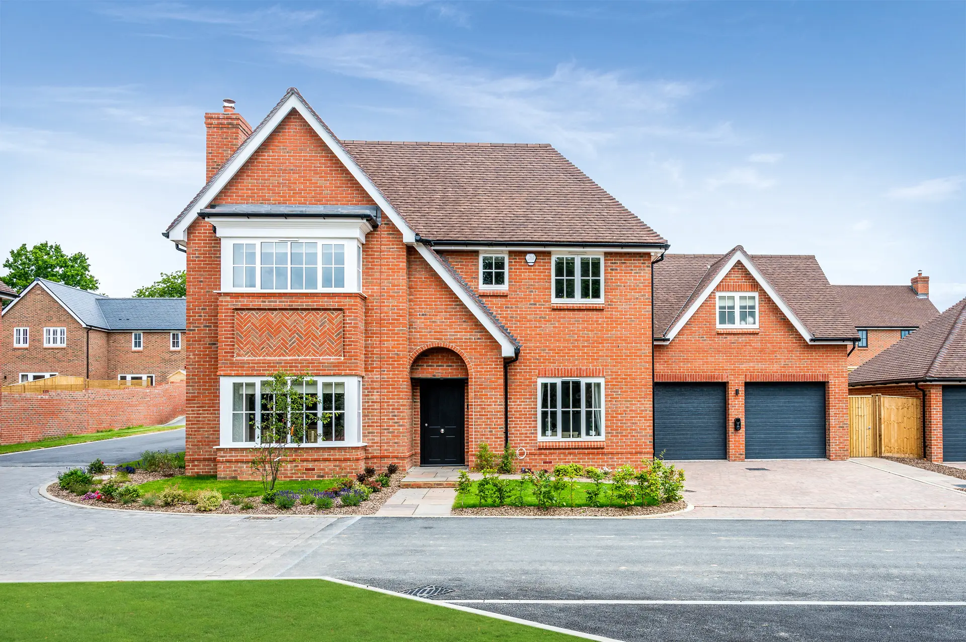 a brick house with a driveway and grass