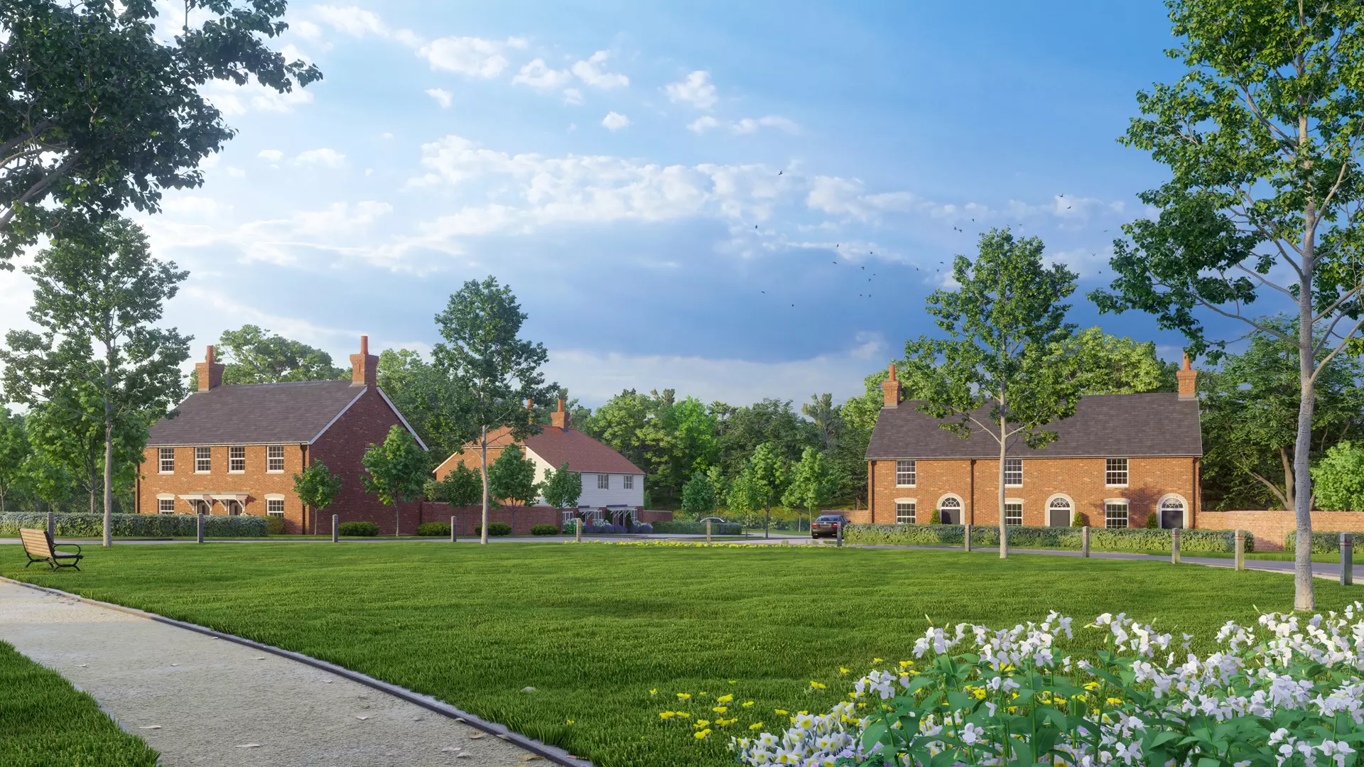 a lawn with trees and houses in the background